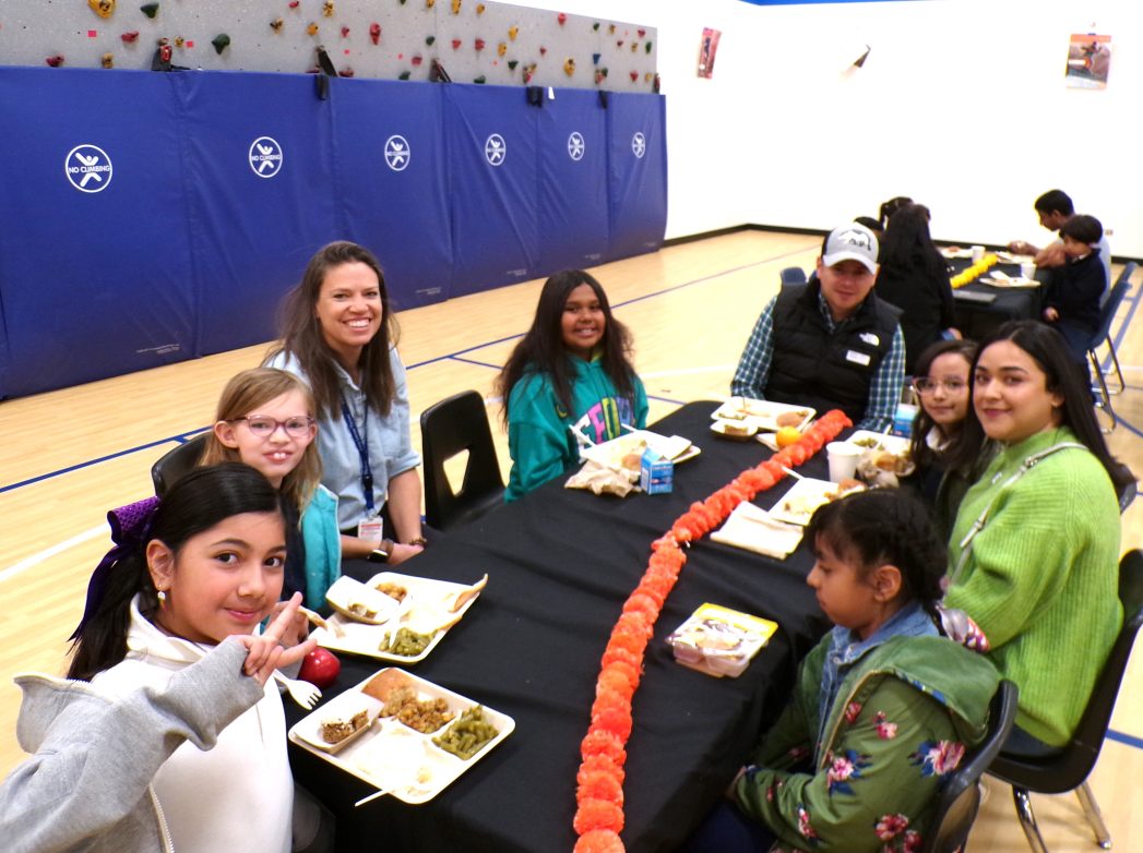 Gallery of photos of students and families eating Thanksgiving lunch