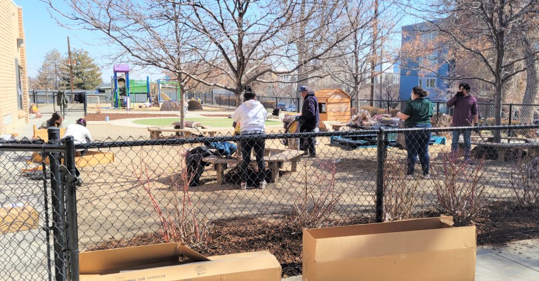 Photos of parents and teachers cleaning up ECE playground and assembling new sandboxes and play kitchens.