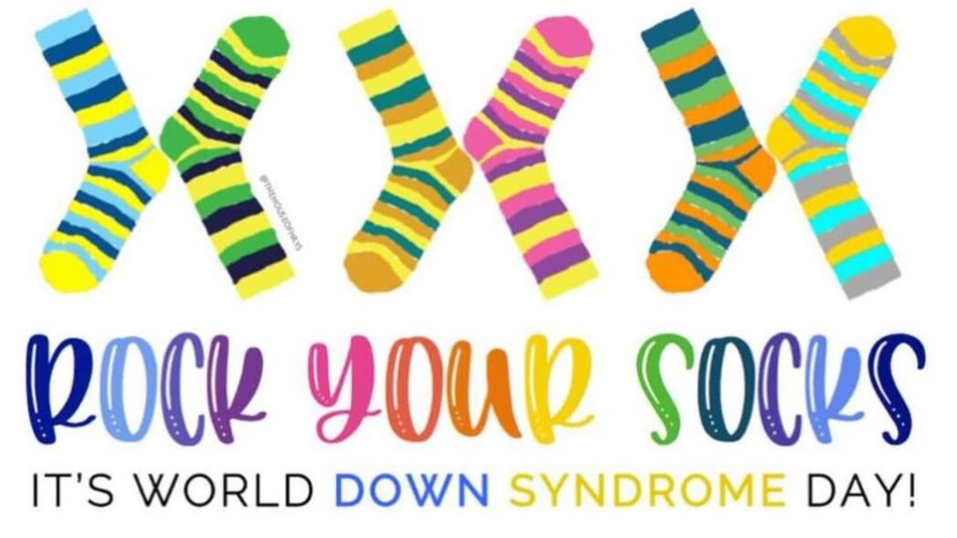 Multicolored image and text on white background. Image of 3 pairs of mismatched socks with the text, " Rock Your Socks" and "It's World Down Syndrome Day" 