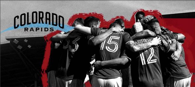 Text says Colorado Rapids over a photo of soccer players with arms around each other.