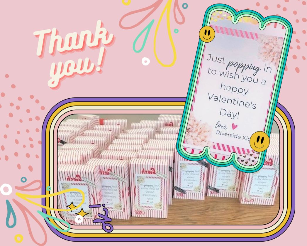 Pink background with white text "Thank you!" and photo of a bunch of boxes of popcorn on a table and a smaller photo of the front of the popcorn box "Just poppin in to wish you a Happy Valentine's Day! love, Riverside kids" 