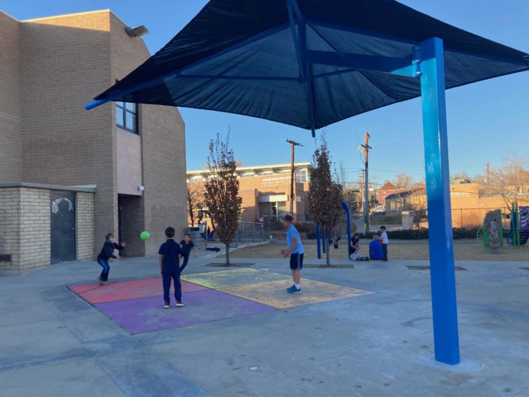 image of shade structure covering Valdez playground while students play foursquare