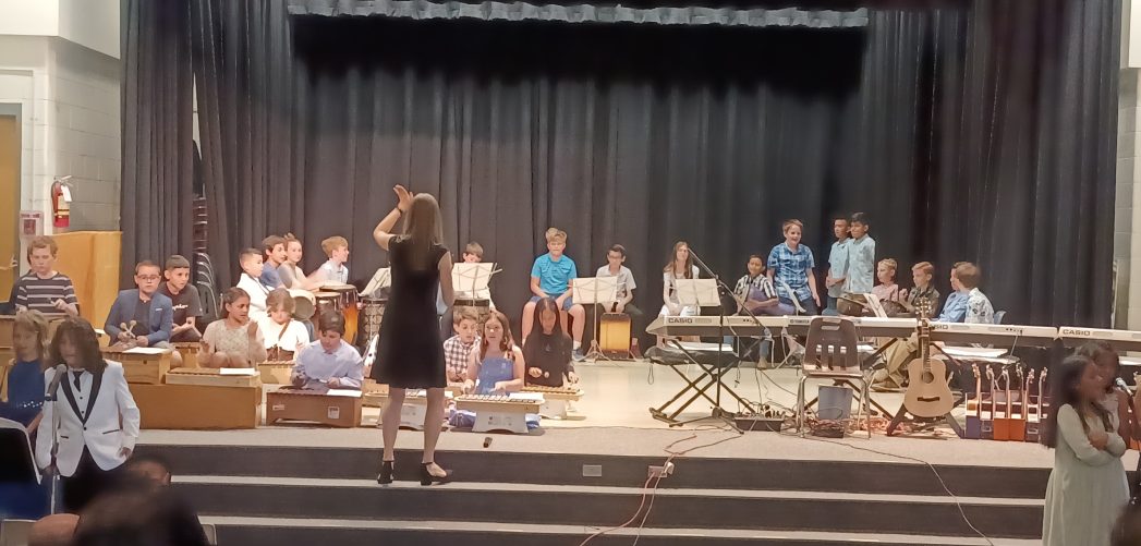 Teacher conducting student choir
