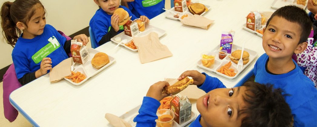 Photo of students eating lunch at a table