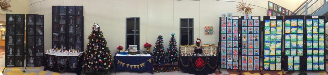 Image of art displays featuring Valdez student artwork and 3 Christmas trees