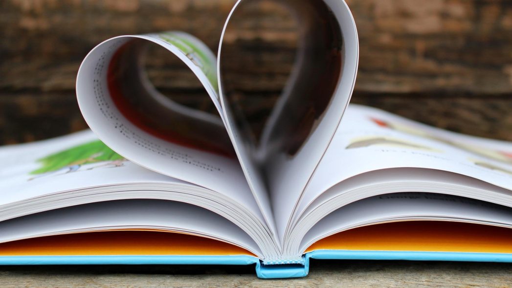 Image of a book with some pages folded into a heart-shape