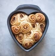 Photo of a heart-shaped pan filled with cinnamon rolls