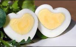 Photo of two halves of a hard-boiled egg shaped like hearts.