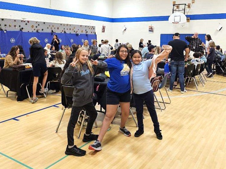 Photos of students and families eating Thanksgiving lunch