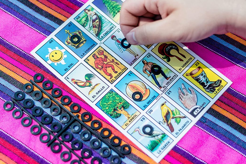 Image of a hand placing a playing piece on a lotería card.