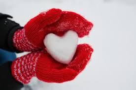 Hands holding snowball heart