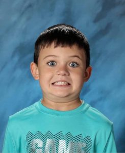 Kid smiling for class photo